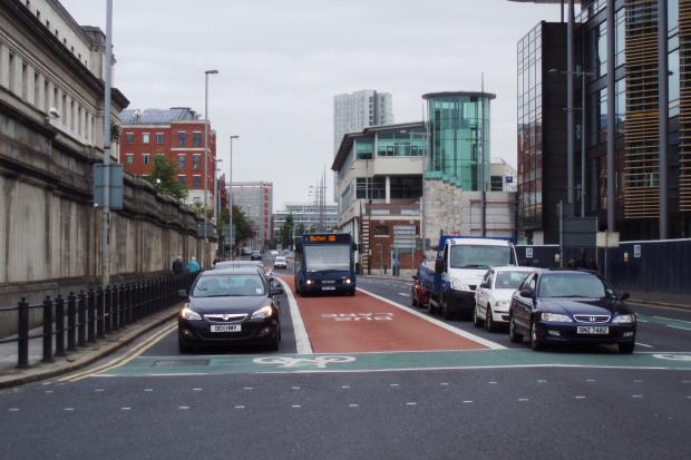 Bus lanes red surfacing between solid white lines