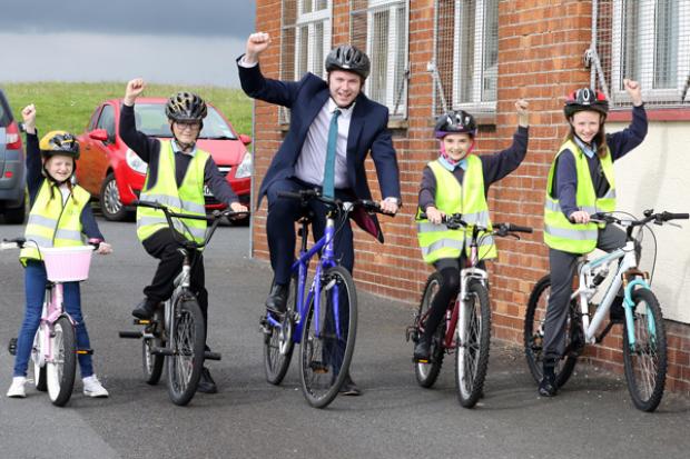 Minister Hazzard celebrates Bike to School Day with pupils from St Colmcille's Primary School