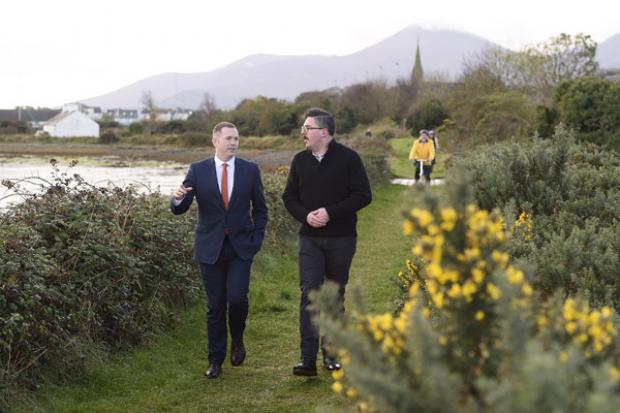 Infrastructure Minister Chris Hazzard and Jonathan Hobbs from NI Greenways enjoy a walk along the old railway track near Dundrum